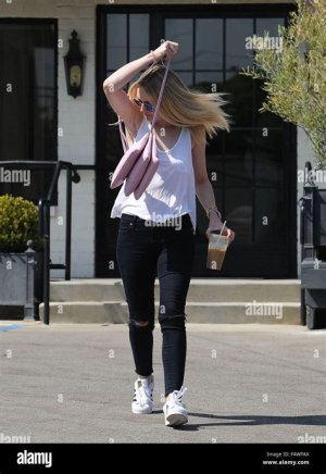 Dakota Fanning wearing didas Originals 'Superstar 80s DLX' sneakers