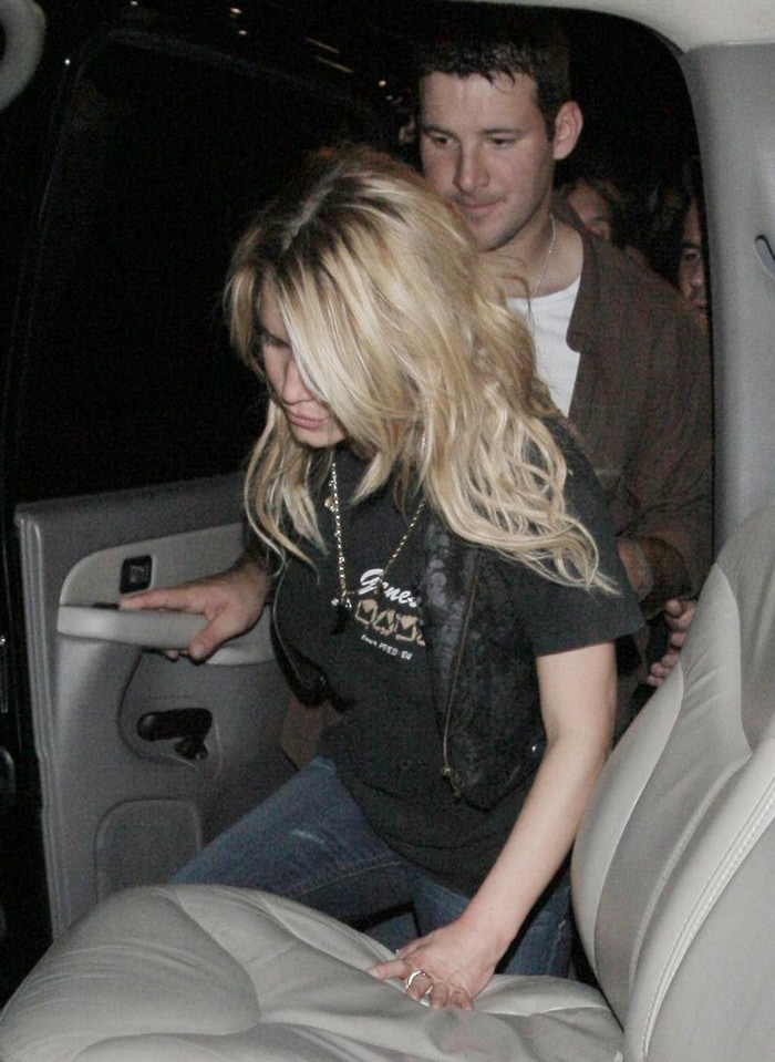 A very intoxicated Jessica Simpson is helped into her car by her boyfriend Tony Romo after seeing '80s metal/hard rock tribute band Metal Skool perform at the Key Club on the Sunset Strip in Hollywood