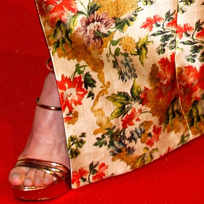 The gown&rsquo;s sweeping hem opens just enough to showcase her gleaming platform heels on the red carpet