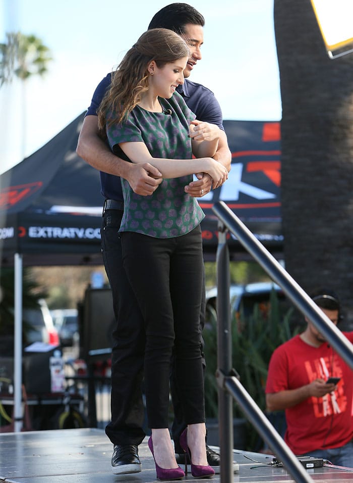 Anna Kendrick with host Mario Lopez for an appearance on Extra at the Universal Studios in Los Angeles on February 11, 2015