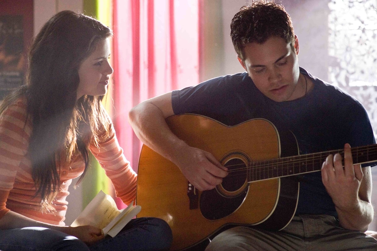 Selena Gomez shares a quiet moment with co-star Drew Seeley as their characters bond over music in Another Cinderella Story, highlighting the film&rsquo;s modern, performance-driven twist on the classic fairy tale