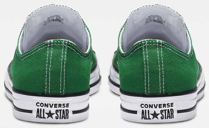 Authentic green Converse Chuck Taylor All Star low-top sneakers featuring the signature white rubber heel patch with black branding