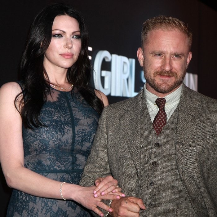 Laura Prepon towers over her husband Ben Foster as they pose together&mdash;she exudes elegance in a sheer navy lace dress, while Foster keeps it classic in a textured three-piece brown tweed suit paired with a maroon patterned tie and striped shirt