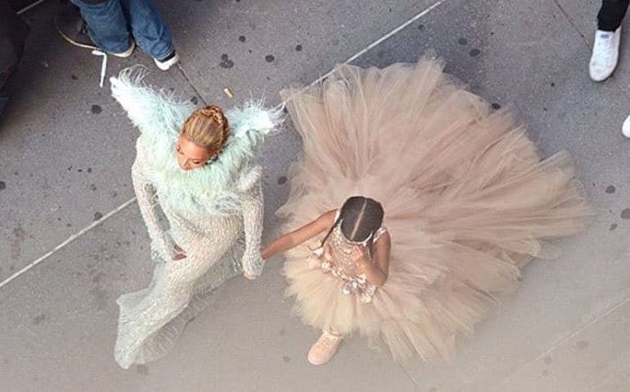 Beyonc&eacute; and daughter turn heads in their coordinated outfits as they make their way through the crowd
