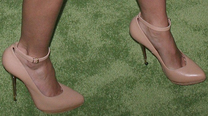 Cameron Diaz elegantly showcases her feet in chic nude ankle-strap heels, a timeless choice that enhances her leg-lengthening silhouette