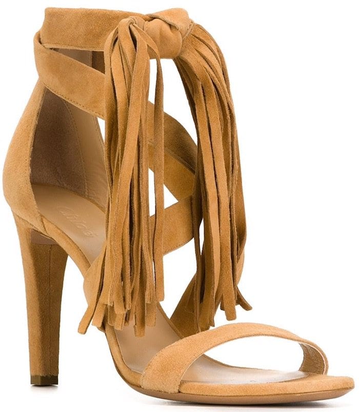 Chlo&eacute; fringed suede sandals in warm tan, finished with a knotted ankle tie and cascading fringe that adds fluid movement to the minimalist silhouette