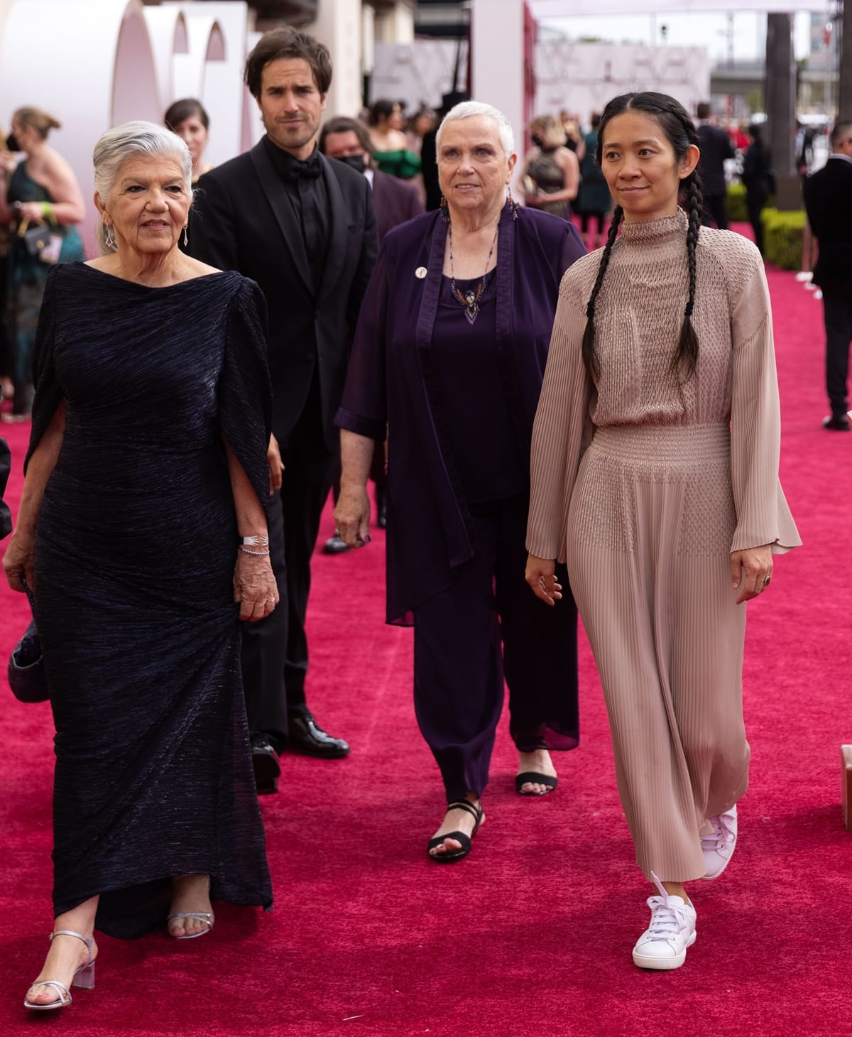 Chloe Zhao walked the red carpet in a beaded Herm&egrave;s dress and white sneakers