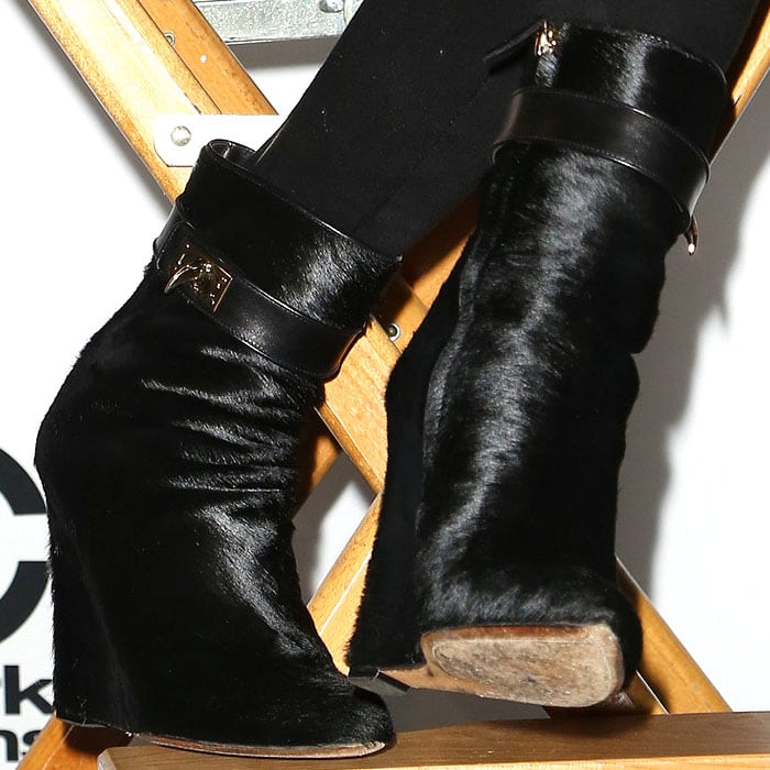 Close up on Chrissy Teigen&rsquo;s edgy footwear choice: black Givenchy pony-hair sharktooth ankle boots with a slouched silhouette and angular heel, adding texture and attitude to her all-black press-conference look