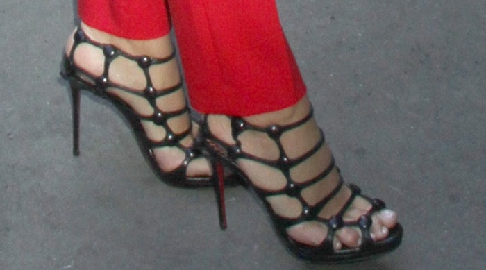 Blake Lively showcases a flawless pedicure in bold black Christian Louboutin &ldquo;Neuron&rdquo; cage heels, adding edge to her striking red suit