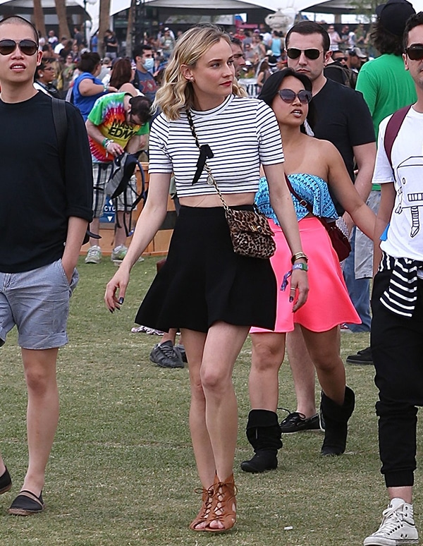 Moving through the crowd, Diane Kruger&rsquo;s flared skirt and striped crop top create a breezy silhouette that feels perfectly in tune with the festival atmosphere