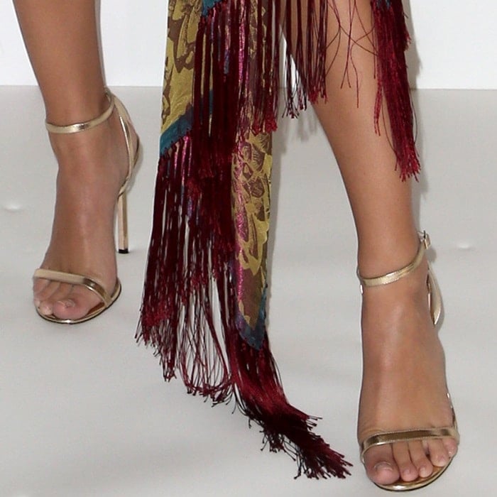 Emily Ratajkowski highlights her polished pedicure in metallic strappy Jimmy Choo &lsquo;Minny&rsquo; sandals, adding a sleek finish to her fringed Oscar de la Renta look at TheWrap&rsquo;s Power Women Summit