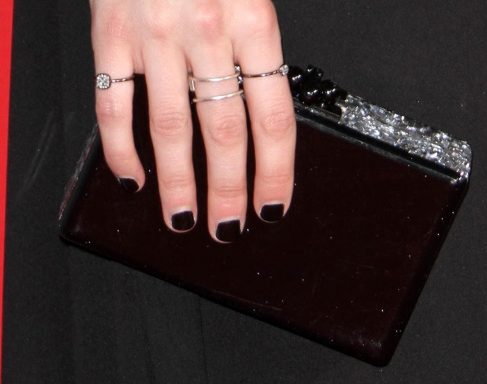 Emma Roberts totes&nbsp;an Edie Parker acrylic clutch and shows off her Meredith Marks rings