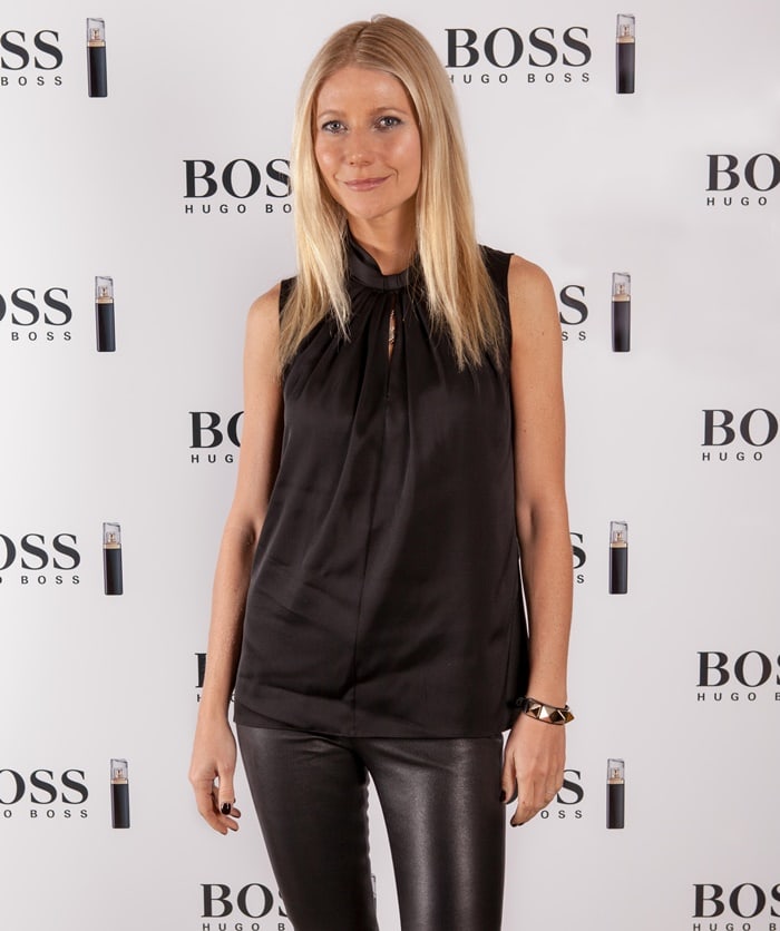 Gwyneth Paltrow stayed professionally stylish in her bright red Gianvito Rossi suede pumps with a beige skirt and a blue blouse