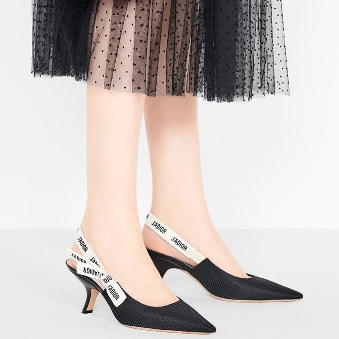 Dior&rsquo;s black technical fabric J&rsquo;Adior slingbacks combine a sculpted pointed toe with the house&rsquo;s signature embroidered ribbon straps, creating a sleek logo-driven pump that became a defining late-2010s luxury staple