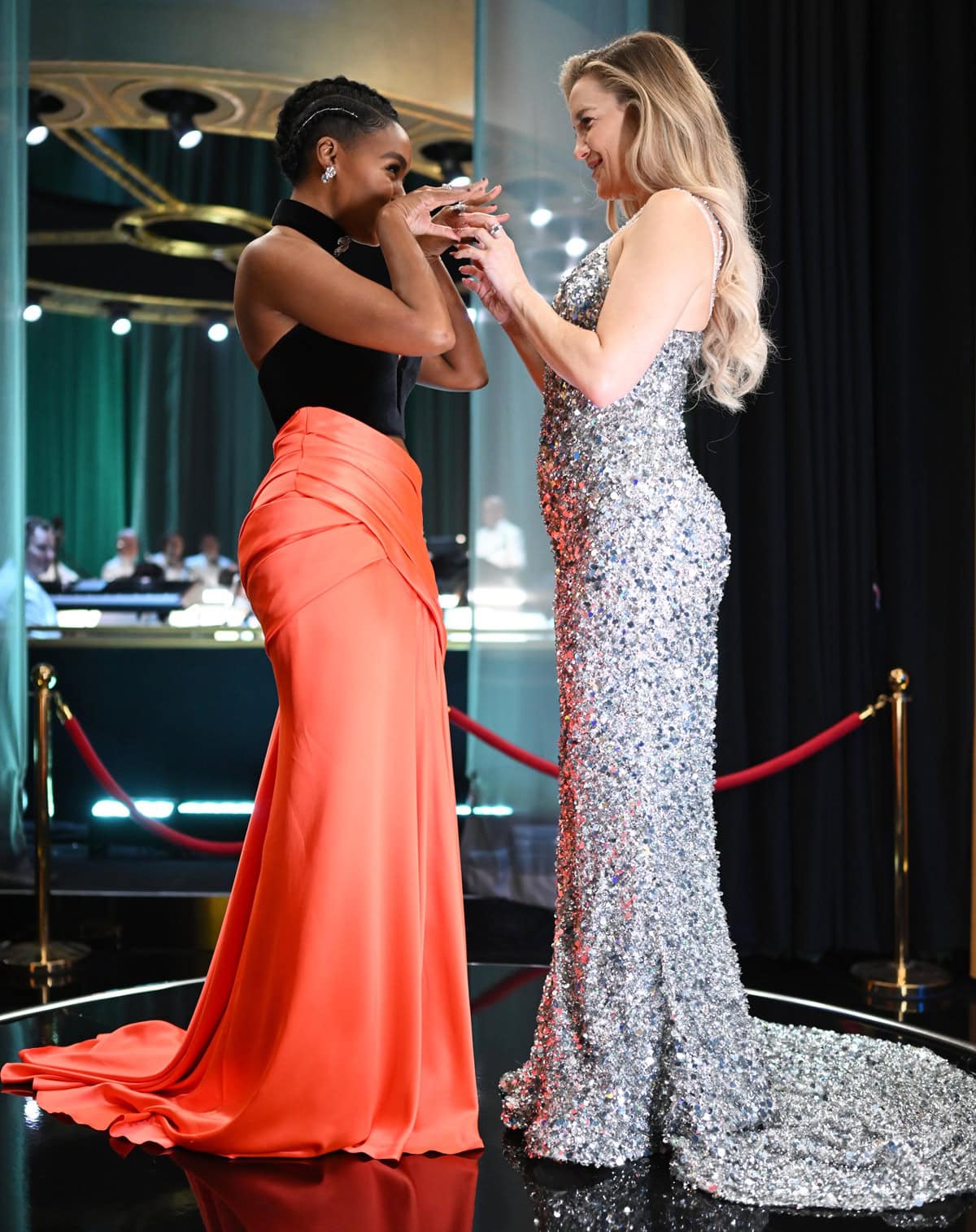 Janelle Mon&aacute;e stuns in a bold black-and-orange Vera Wang ensemble alongside the statuesque Kate Hudson in a shimmering silver gown, highlighting their striking height contrast
