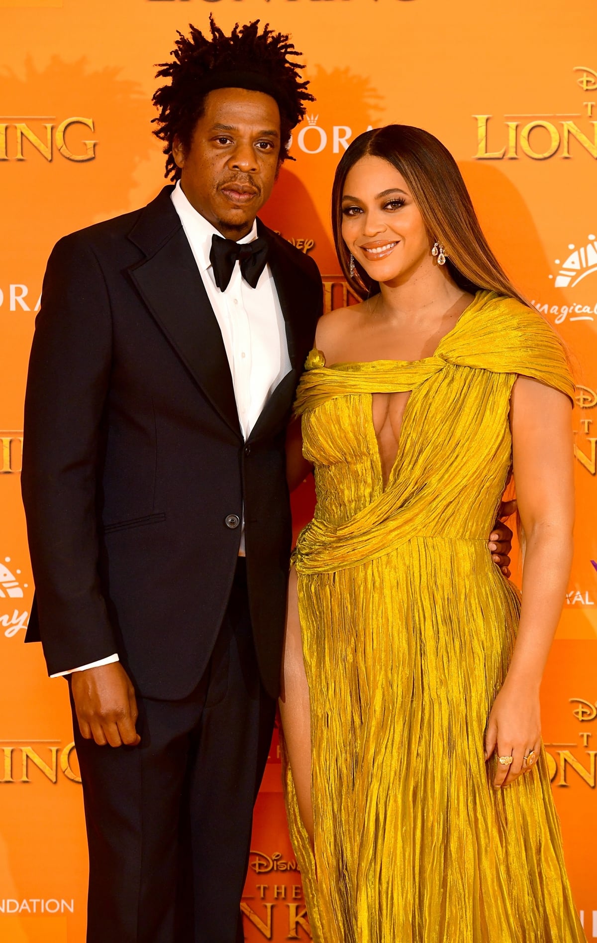 Beyonc&eacute; stuns in a gold pleated gown while Jay-Z looks dapper in a classic tuxedo at the premiere of The Lion King