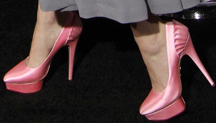 Her pink satin Charlotte Olympia &ldquo;Paloma&rdquo; platform pumps add a glamorous pop of color and perfectly tie together her soft, retro-inspired ensemble