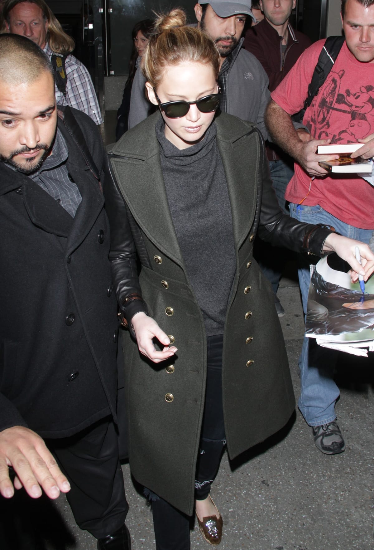 Jennifer Lawrence was stylishly dressed in a Burberry London leather sleeve coat, AG Adriano Goldschmied super skinny legging jeans and Dolce & Gabbana embellished loafers