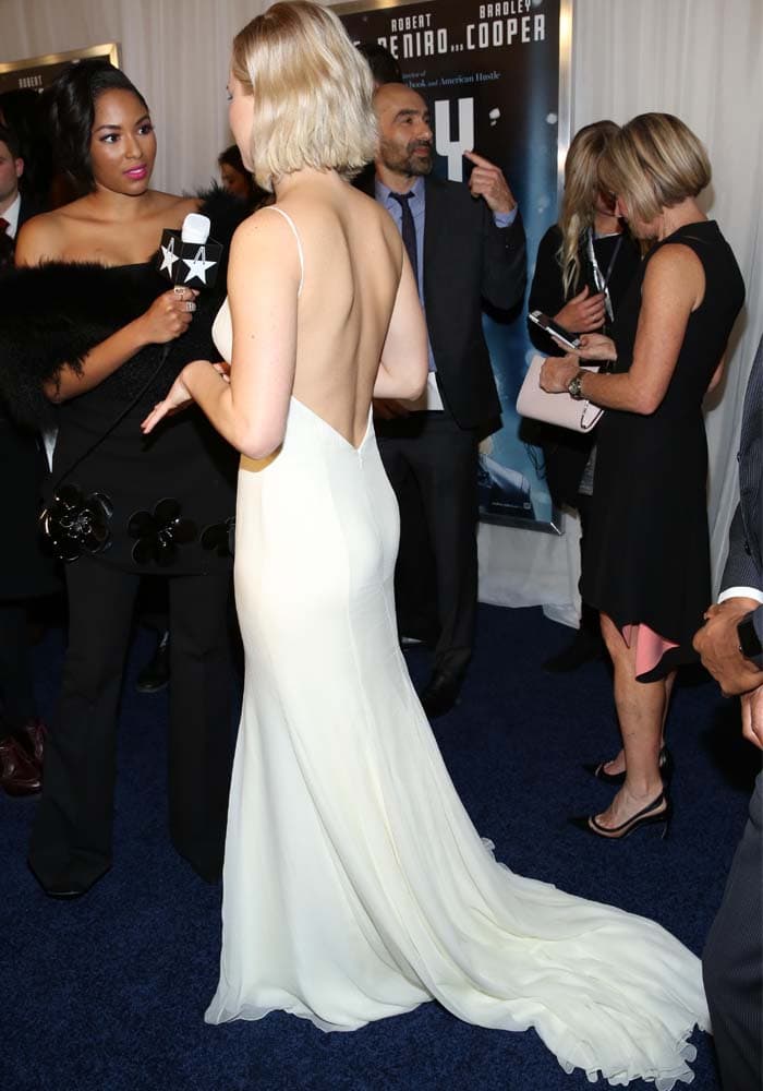 Jennifer Lawrence shows off the train on her white Christian Dior gown