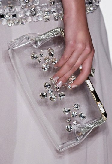 Jenny Packham's 'Mystery Palace' Clear Clutch, priced at &pound;515, showcases modern elegance with its structured metal frame and embedded Swarovski crystals
