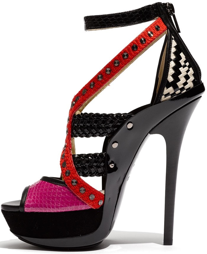 An eye-catching m&eacute;lange of straps&mdash;from studded fabric to glossy patent and snake-embossed leather&mdash;shape a bold sandal with a sky-high heel and substantial platform