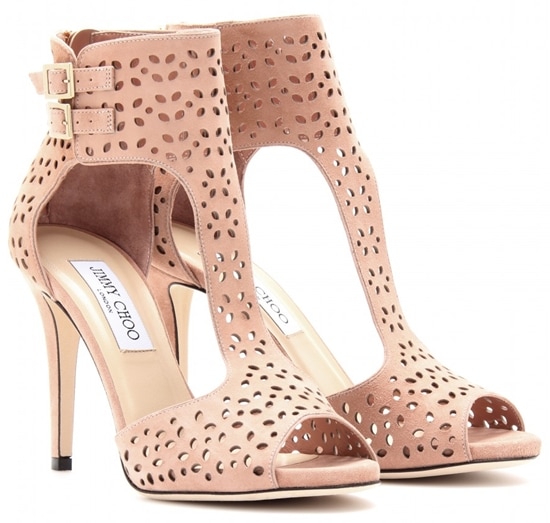 Rendered in soft blush suede, the Jimmy Choo &ldquo;Malika&rdquo; booties showcase delicate laser-cut detailing and a lighter, more feminine take on the architectural design
