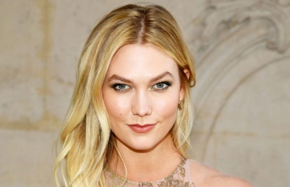 Casual Glamour: Karlie Kloss rocks her flared jeans with a cropped pullover, blending effortless style with retro flair
