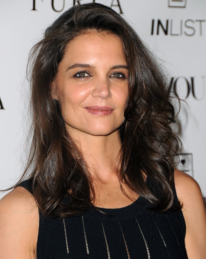 Katie Holmes&nbsp;in a black stretch-knit dress by Azzedine Ala&iuml;a featuring ladder-effect vertical stripes