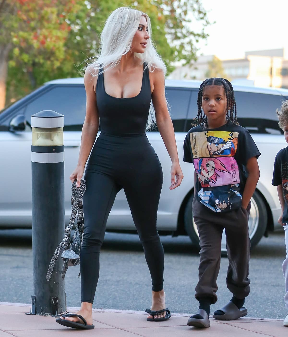 Kim Kardashian keeps it casual in Balenciaga Flip sandals, pairing them with a curve-hugging Skims All in One Shine onesie as she arrives with her son Saint to watch North&rsquo;s basketball game in Calabasas on October 21, 2022