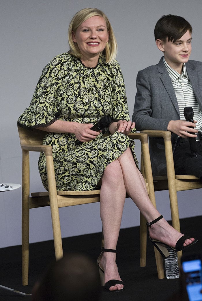 Kirsten Dunst keeps it effortlessly polished in a chartreuse floral dress, grounding the look with black Manolo Blahnik &ldquo;Lauratopri&rdquo; ankle-strap sandals that subtly elongate her silhouette