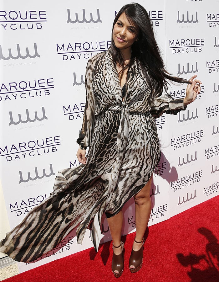 Proving that she&rsquo;s the best-dressed Kardashian, Kourtney arrived at the luxury resort casino and hotel in a floor-length Roberto Cavalli leopard-print chiffon wrap dress, which gave us a peek at her black halter bikini underneath
