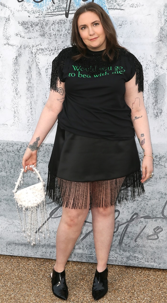 Lena Dunham's slogan print fringe-trimmed T-shirt at the Serpentine Gallery&rsquo;s Summer Party