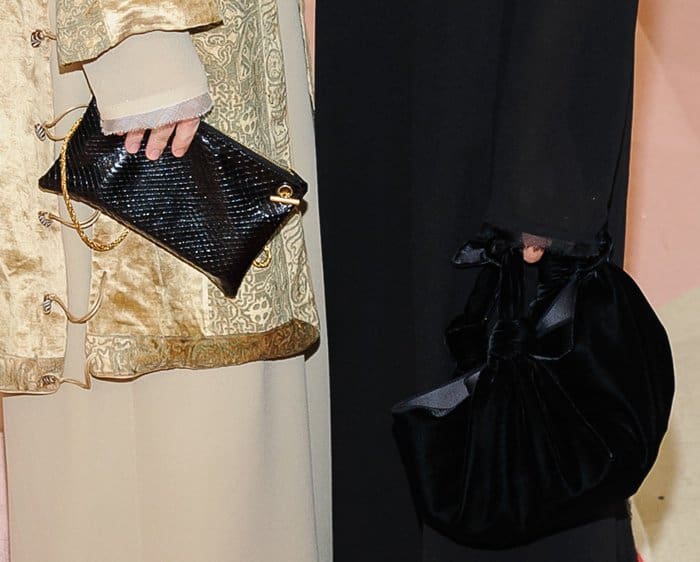 Ashley carried a sleek black crocodile-textured clutch with gold hardware, while Mary-Kate opted for a voluminous black velvet pouch with a knotted bow detail