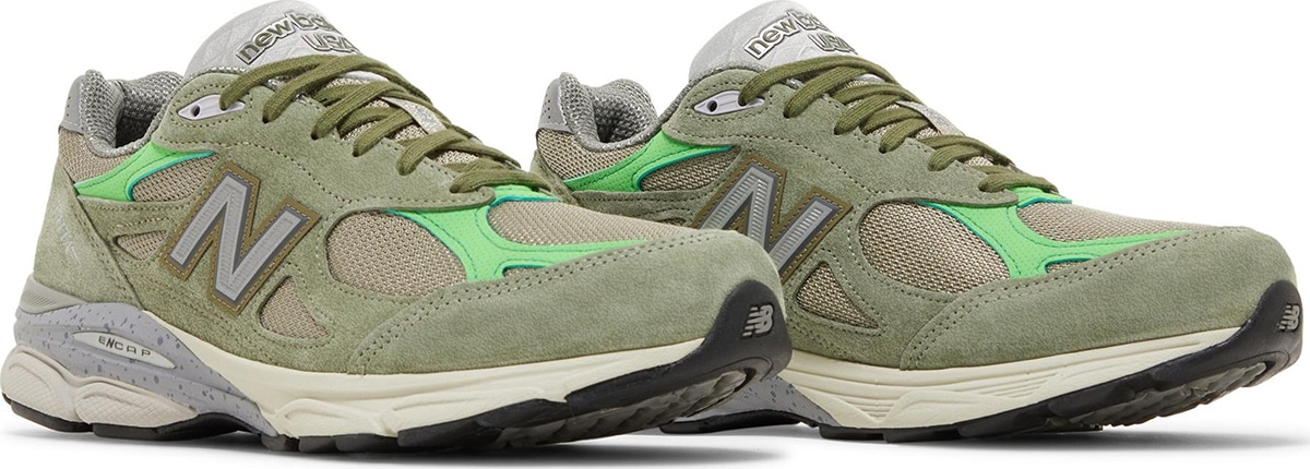 The Patta x New Balance 990v3 Made in USA &lsquo;Keep Your Family Close&rsquo; showcases leafy hues on a lifestyle runner, with a subtle khaki green finish on the mesh and suede upper and neon green microperforated overlays at the toe box and collar