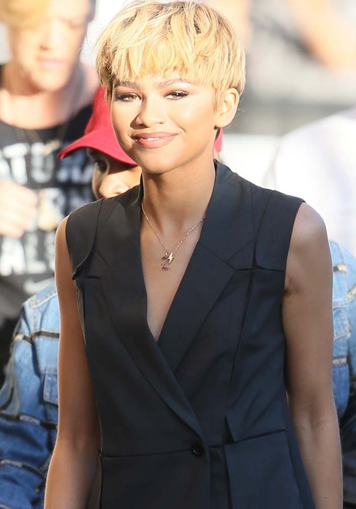 Zendaya exudes effortless style in a sleek, sleeveless black vest dress, paired with a chic blonde pixie cut