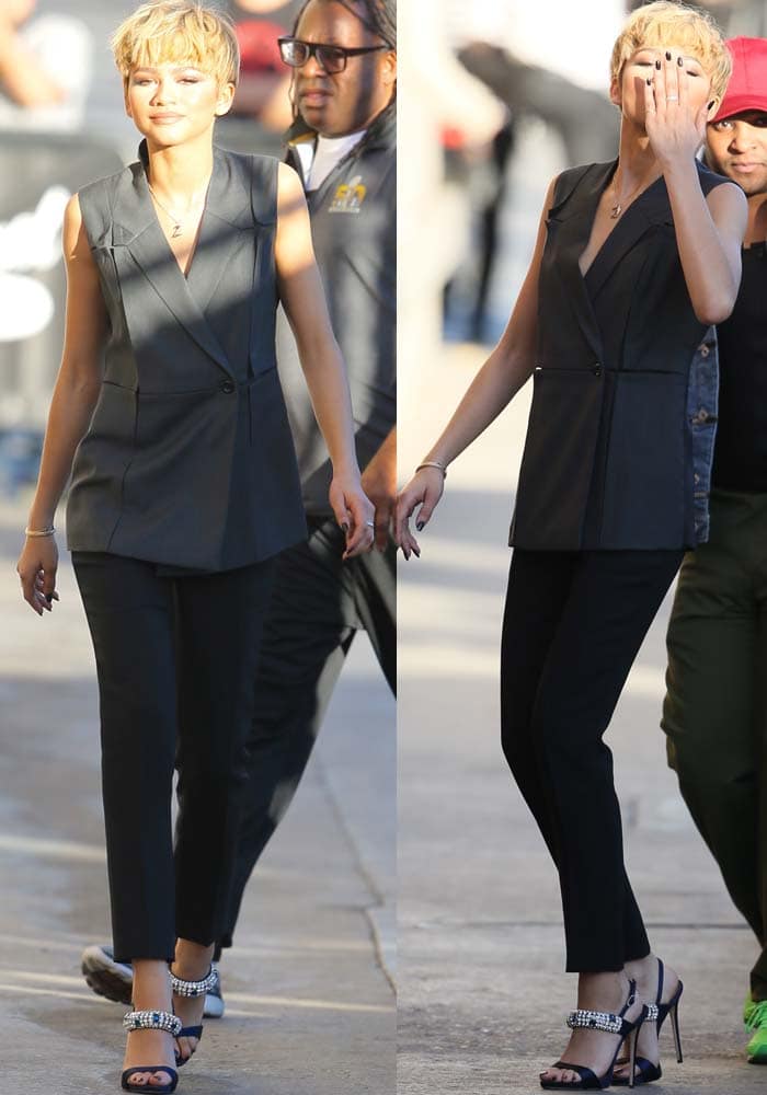 Zendaya stuns in a tailored sleeveless black vest and matching trousers, perfectly complemented by sparkling embellished sandals and a chic blonde pixie cut