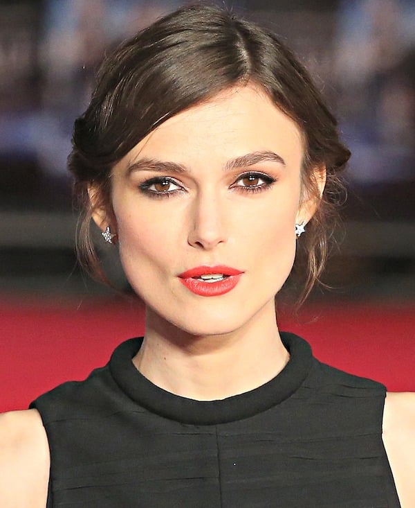 Keira Knightley's&nbsp;hair was styled in a wispy updo, which showcased her star-shaped earrings, kohl-rimmed eyes, and perfect red pout