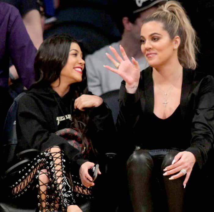 Kourtney Kardashian wearing Yeezy sandals and Khlo&eacute; Kardashian wearing black pointy-toe pumps at Lakers vs. Cavaliers basketball game