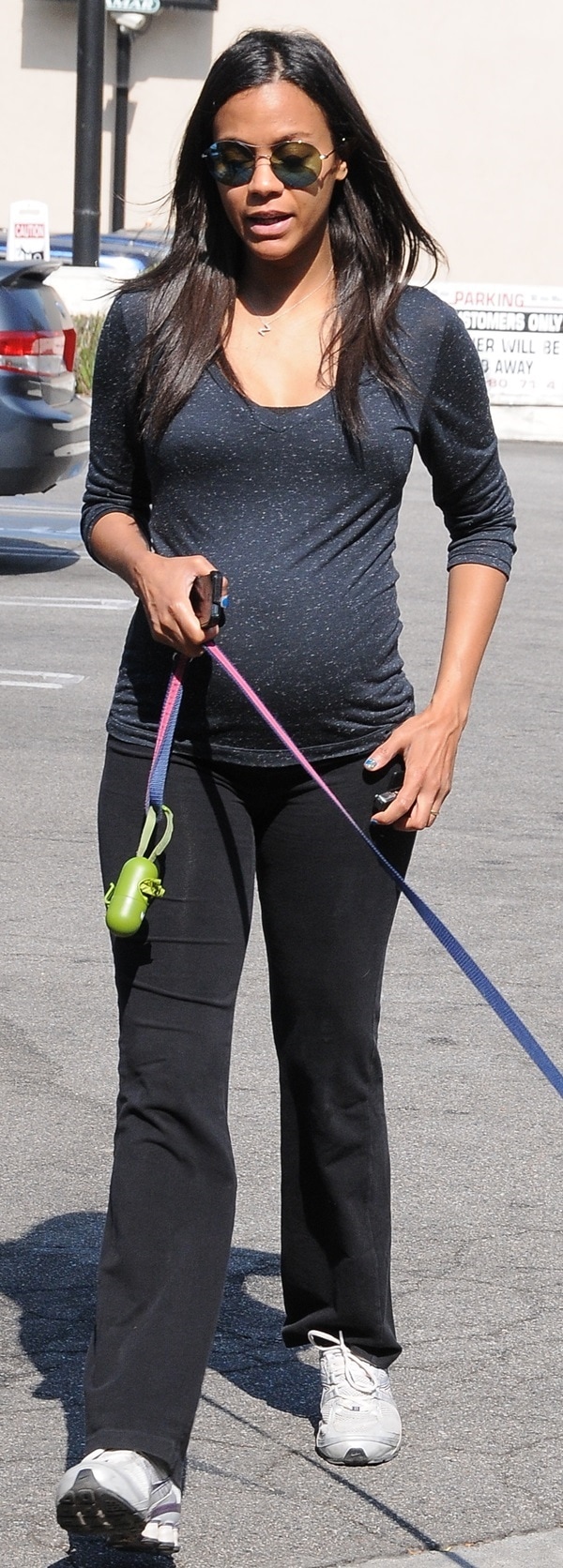 Zoe Salda&ntilde;a wearing a pair of comfortable Nike running shoes while walking her dog in Studio City, California, on August 21, 2014